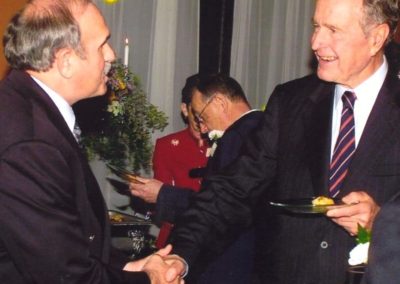 owner of King's Korner shaking the hand of former president George H W Bush