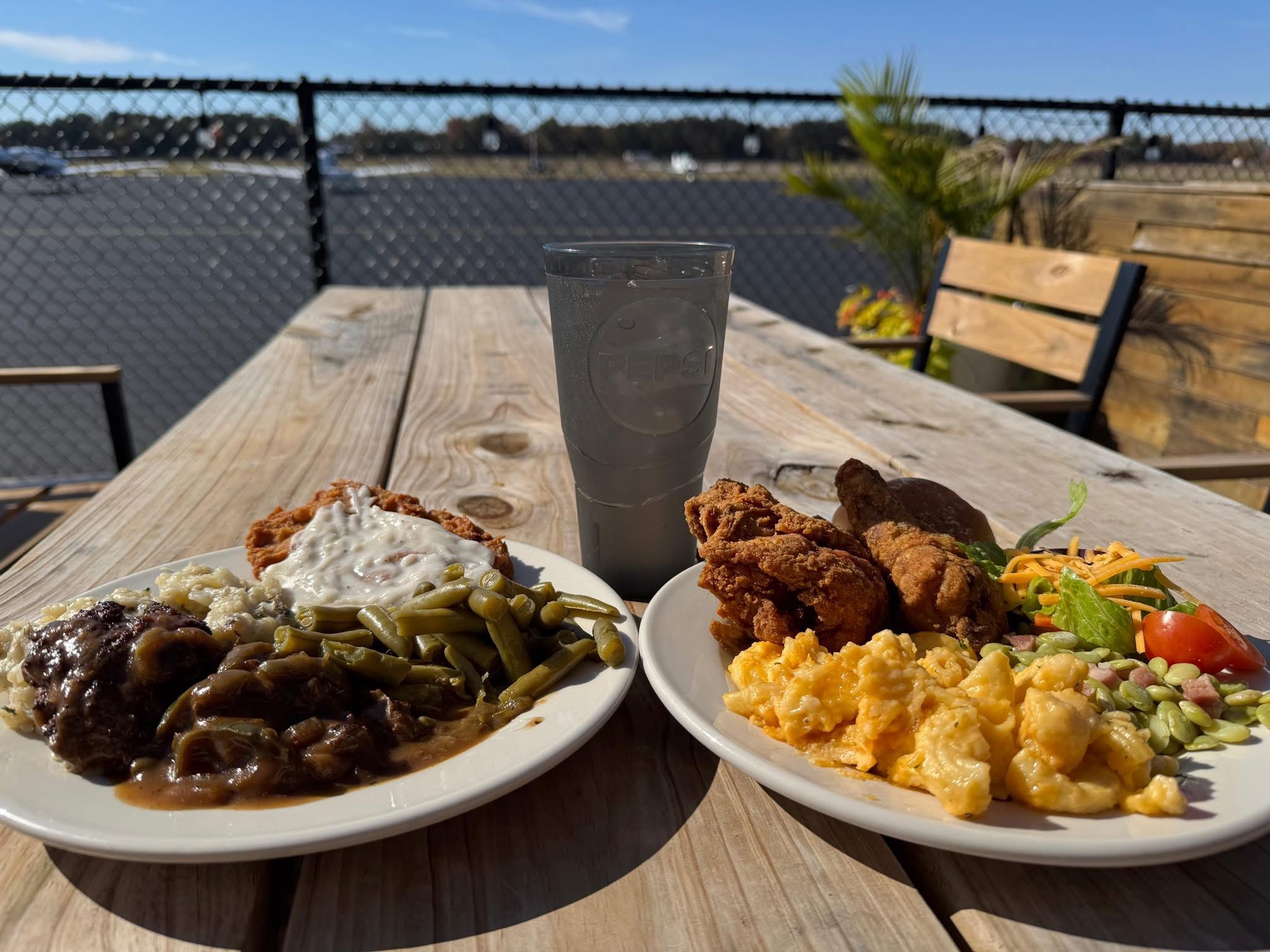 Plates of King’s Korner food on the patio overlooking the runway